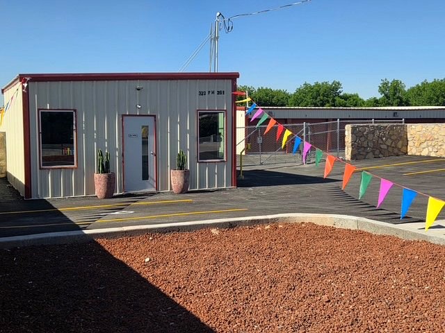 Grand opening at Canutillo Self Storage with festive bunting flags strung across the property.