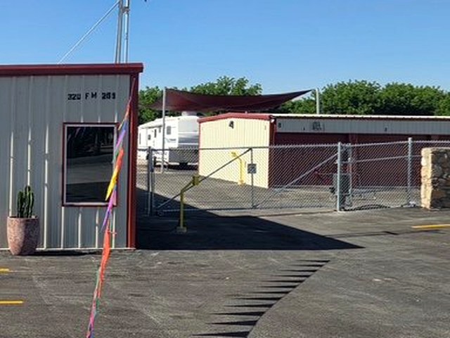 Red canopy covered parking spaces at Canutillo Self Storage, shaded from the West Texas sun.